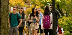 Group of people walking on campus.